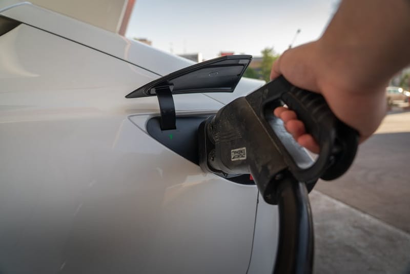 Electric vehicle plugged into a home charger overnight, illustrating smart-scheduled charging on a UK EV-specific tariff