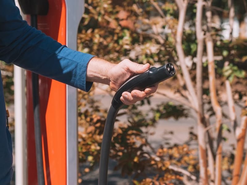 EV charging cable plugged into a car