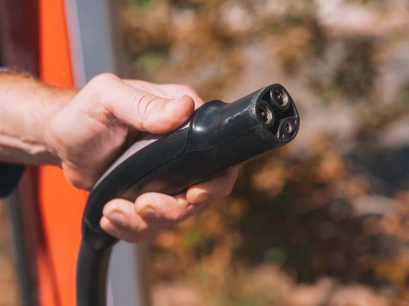 EV charging cable plugged into a UK home wallbox
