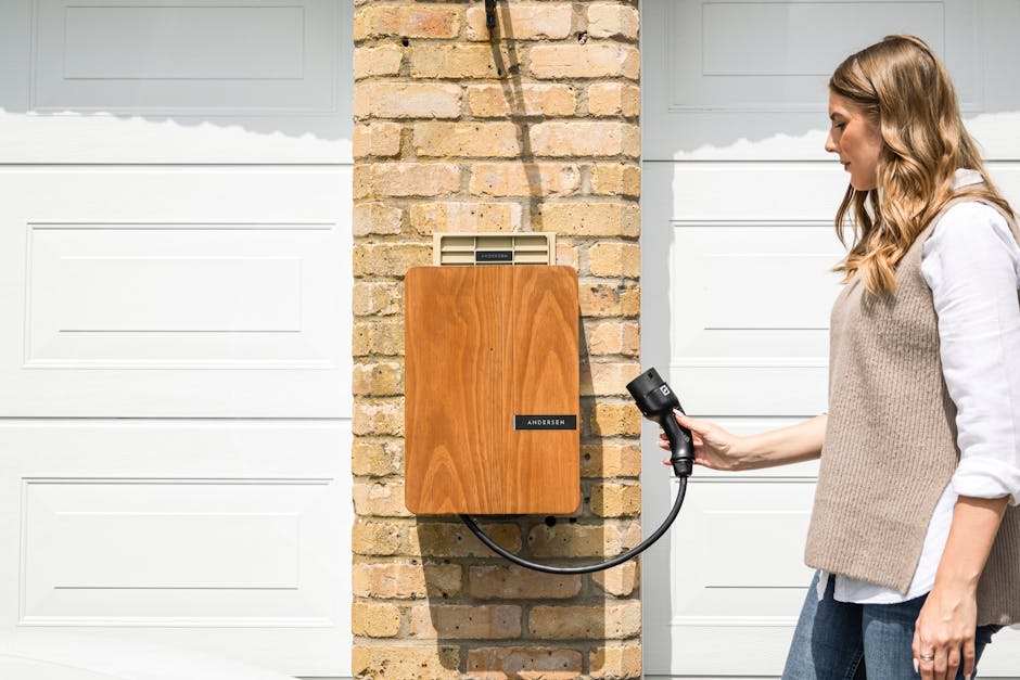 A wall-mounted home EV charger on a UK brick wall, showing typical post-installation appearance.