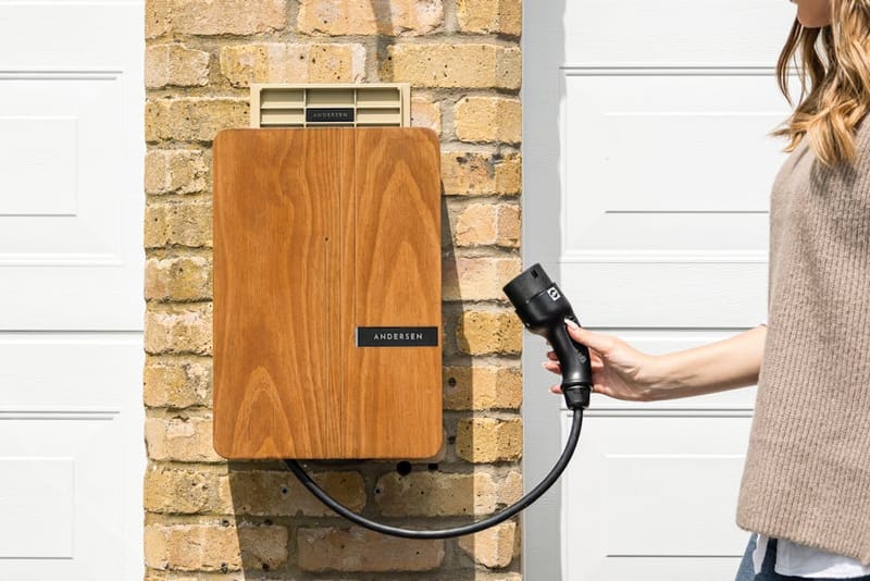 Home EV charger mounted on a wall next to a car charging overnight, illustrating an EDF GoElectric off-peak charging session