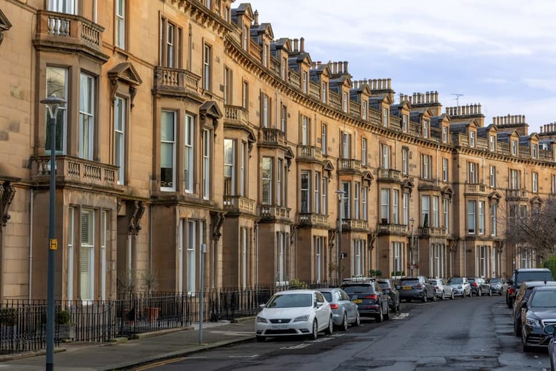 UK terraced residential street with cars parked along the kerb