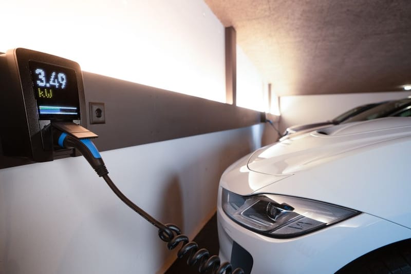 Wall mounted electric car charger on brick